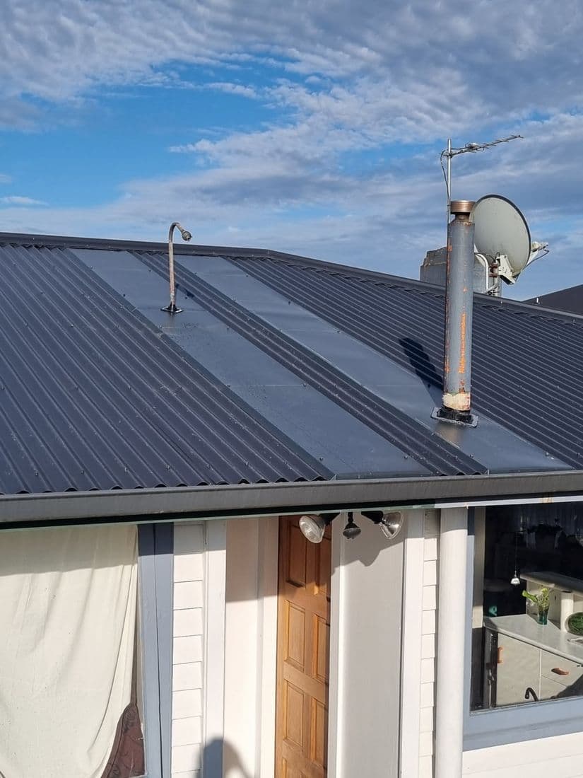 Flashing and penetration detail on a dark roof