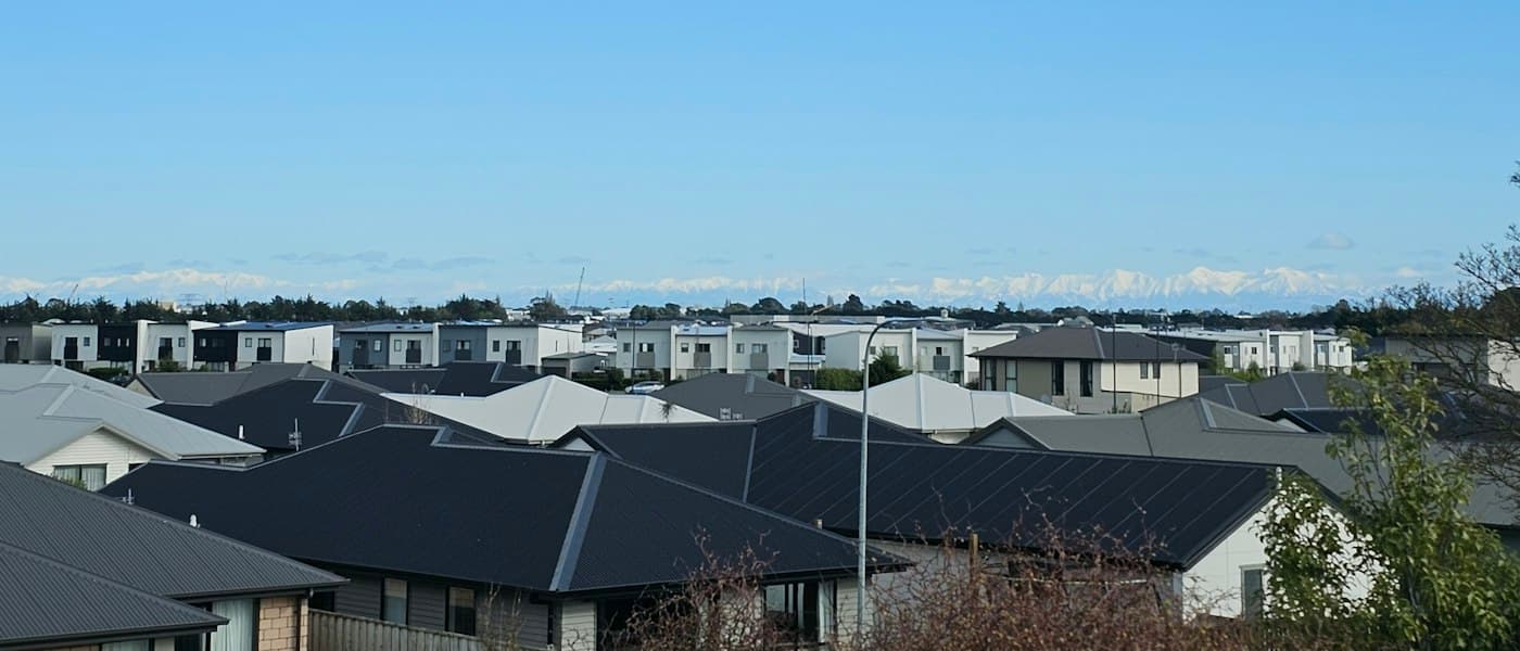 New Zealand suburban rooftops against the hills
